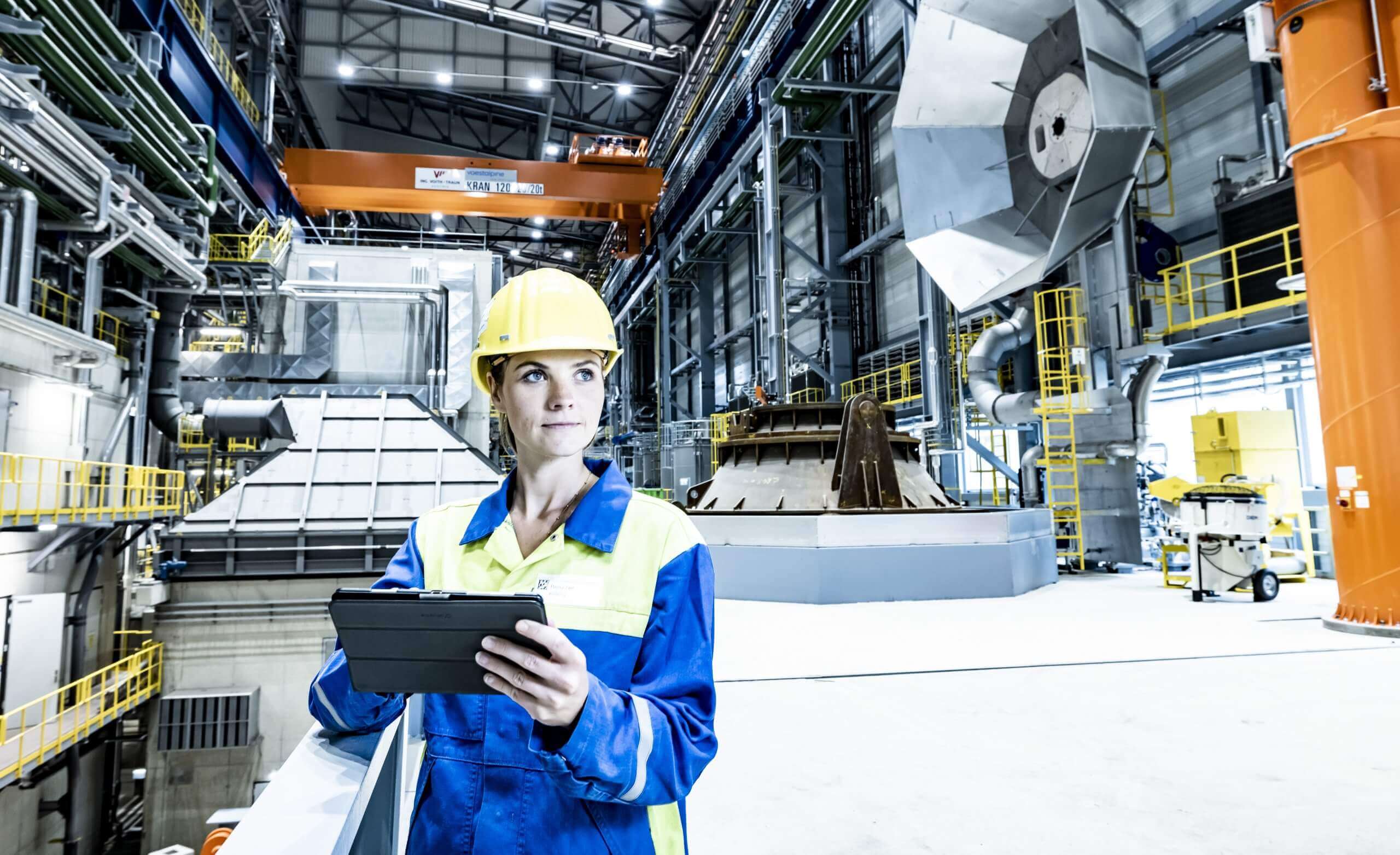 worker in safety gear inside a steel plant